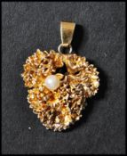 A Danish 925 silver pendant set with a pearl in a foliate motif. Marked Flora Danica 925S Denmark.