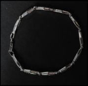 A hallmarked 925 silver bracelet having white stone set and diamond cut pierced links with a lobster