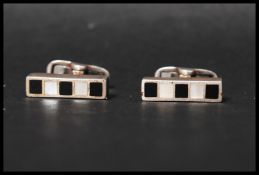 A pair of 925 silver cufflinks set with mother of pearl and onyx. Marked 925.