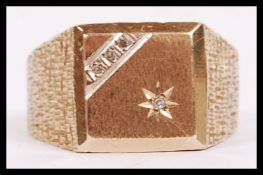 A 9ct gold gentlemans signet ring. The ring  with star set and channel diamonds. Total weight 8.