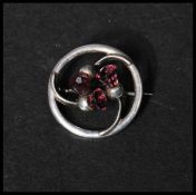 A hallmarked Art Nouveau Charles Horner silver brooch in a Scottish thistle design with amethyst