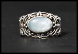 A hallmarked 925 silver ring set with a blue stone in a scroll setting. Hallmarked Sheffield. Size