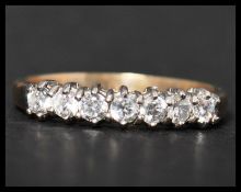 A hallmarked 9ct gold and white stone ring set with 7 white stones. Hallmarked Sheffield. Weight 2.