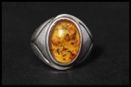 A 925 amber  cabochon ring marked 925. Size Q. Marked 925 with additional foreign mark . Size Q.