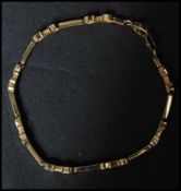 A 18ct gold fancy link bracelet set with white stones having a lobster claw clasp. Marked K18,