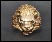 A substantial hallmarked 9ct gold figural ring in the form of a lions head having white stone set