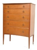 A mid century teak wood Danish influenced tall bachelors chest of drawers. Raised on oversized