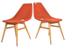 A pair of retro 1950's mid century dining chairs being raised on teak tapering legs with woollen