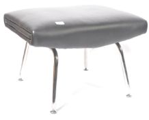A retro chrome and black leather footstool ottoman being raise on chrome tubular frame with twin
