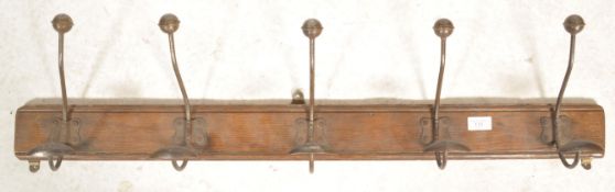 A vintage Industrial 20th century wall mounted coat stand. The oak plinth base with fabulous