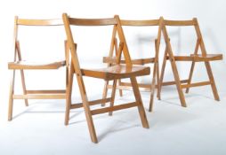 A set of four 20th century dispersal / village hall folding chairs being stamped to the rear with