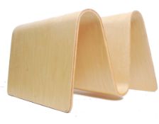 A retro 20th century bentwood magazine rack in the manner of Isokon. The wave shaped bentwood rack
