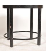 A vintage retro 20th century lacquered circular table having an abstract geometric orbital design.