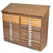 An early 20th century large Industrial oak 32 drawer printers filing cabinet / draughtsmans board.