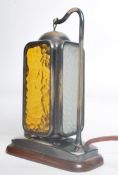 A mid century / 1950's  table lamp raised on mahogany base with polished steel plinth having a
