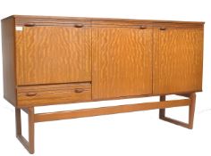 A mid century teak wood sideboard by Nathan. Raised on a suspension set turned leg and drop centre