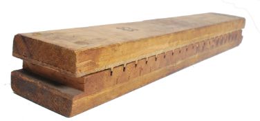 A vintage wooden 20trh century continental cigar press of long rectangular form being marked for