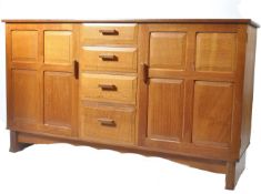 A mid 20th Century Heals oak Arts & Crafts sideboard. The very heavy solid oak sideboard being