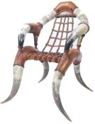 A stunning 20th century cow horn and leather armchair in the manner of Michel Haillard, the main