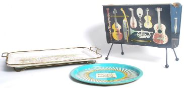 A vintage 20th century retro magazine rack having musical instrument decoration along with two retro