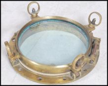 A stunning  early 20th century brass shipping porthole window's with backing plates on  fitted