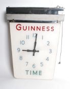 A vintage early 20th century Guinness electric glass and chrome wall clock having a chrome light