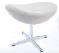 After Arne Jacobsen. A polished steel and beige upholstered egg stool - foot stool. The polished