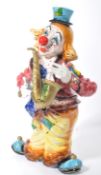 A fantastic 20th century ceramic floor standing clown, finished with an enamel glaze, the clown