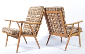 A fantastic pair of low Scandart easy armchairs in stained beech having angular form. The cushions