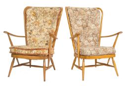 A good pair of 20th century retro Ercol Windsor pattern armchairs. The turned legs united by