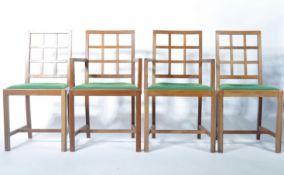 A set of mid 20th Century Heals oak ' Tilden ' dining chairs.The solid oak chairs being raised on