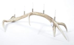 A stunning 20th century taxidermy stags antler up cycled as a candelabra centre piece, the five