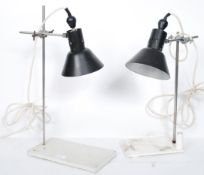 A pair of vintage retro 20th century industrial desk lamps having black enamel pendant shades