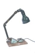 A vintage 20th century Industrial Memlite style anglepoise desk - wall mounted work lamp in original
