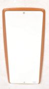 A 20th century retro, circa 1970's atomic teak wall mirror. The frameless mirror applied to a shaped