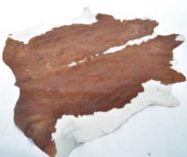 A retro 20th century large pony skin hide rug having brown and white fur ( see illustrations )