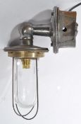 A 20th century Industrial cast metal heavy set bulkhead / dairy lamp with caged pendant style bulb