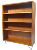 A vintage 20th century retro teak wood upright open window bookcase cabinet being raised on