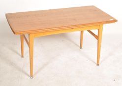 A mid century Swedish metamorphic teak wood coffee table. Of rectangular form being raised on