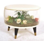 A vintage retro mid 20th century kitsch Puffin inflatable Pouffe Ottoman raised on four tapering