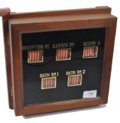 An Edwardian servants 5 division bell casing / butlers call box with a wooden casing and glass front