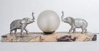 A 1930's Art Deco rouge marble and elephant table lamp. The silvered elepants flanking a frosted