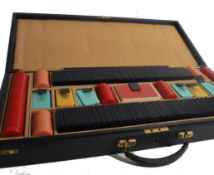 A vintage mid 20th century leather cased set of poker - gambling ships in sterling currency. The