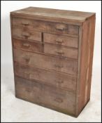 A vintage 20th century workmans / engineers oak  bank of drawers comprising of a series of short and
