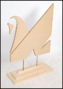 A contemporary handmade advertising point of sale swan sculpture constructed of panel wood and