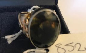 A 14ct gold diamond and citrine ring. The ring being set with a large bicolour oval citrine of green