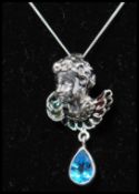 A 925 silver Art Nouveau style pendant necklace strung with a cherub bust set with emerald green,
