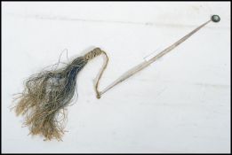 A Chinese silver bookmark with tassel end with turquoise stone finial.