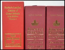 Three Volumes of Burkes Peerage, Baronetage and Knightage 107th Edition with the folder .stand