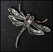 A 925 silver figural brooch in the form of  a dragon fly set with marcasite with green and red